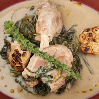 Greek fricassee with goat and wild greens in avgolemono sauce, served in a traditional clay pot