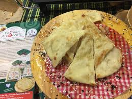 Vegan Greek olive oil cake from Samos, sliced into pieces on a wooden board