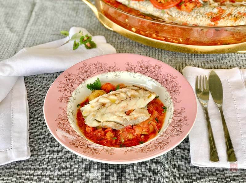 Greek fish plaki baked with tomato, raisins, and Samos wine – traditional Aegean recipe