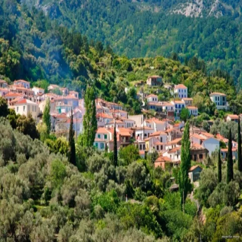 Panoramic view of Vourliotes village in Samos with traditional houses and lush greenery.
